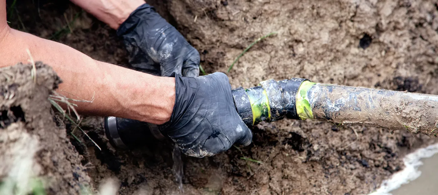 PR Septic Service technician repairing septic pipe connections